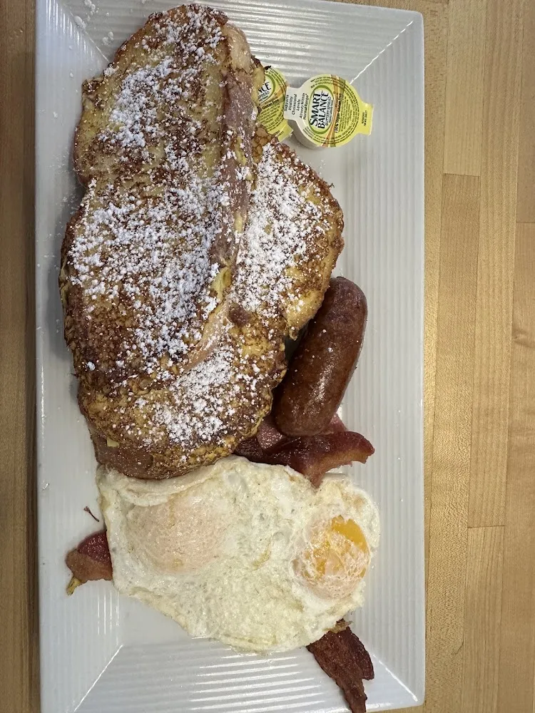 Texas French Toast with Sausage Bacon and over Easy Eggs